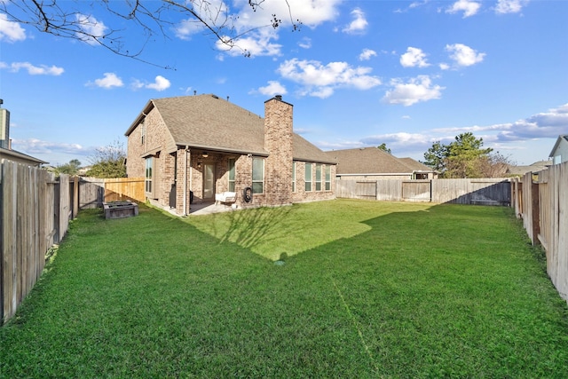 back of house with a patio and a yard