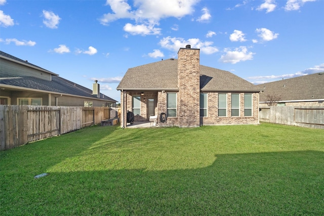 back of property featuring a lawn and a patio