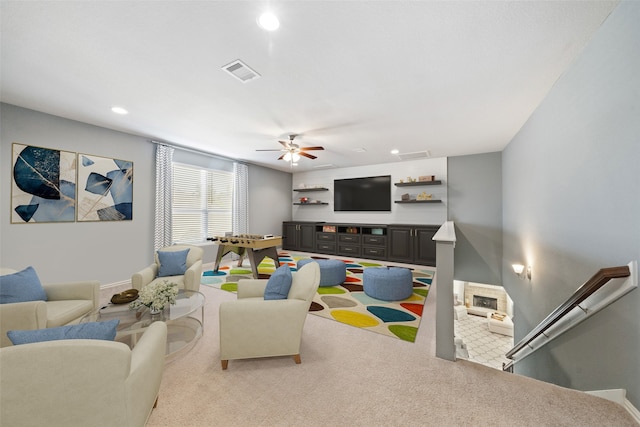 carpeted living room with ceiling fan