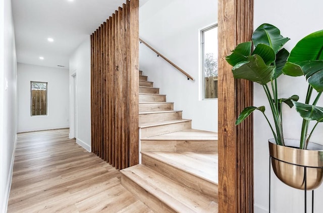 stairs featuring wood-type flooring