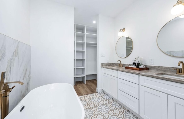 bathroom featuring vanity and a tub