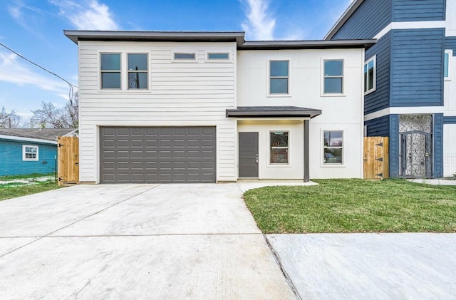 view of front of house featuring a garage and a front lawn