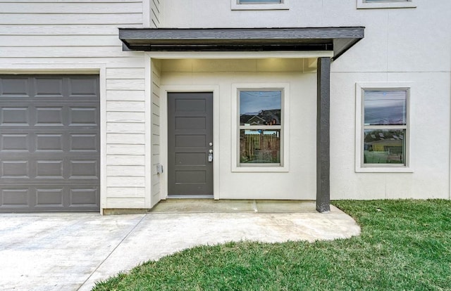 view of exterior entry with a garage