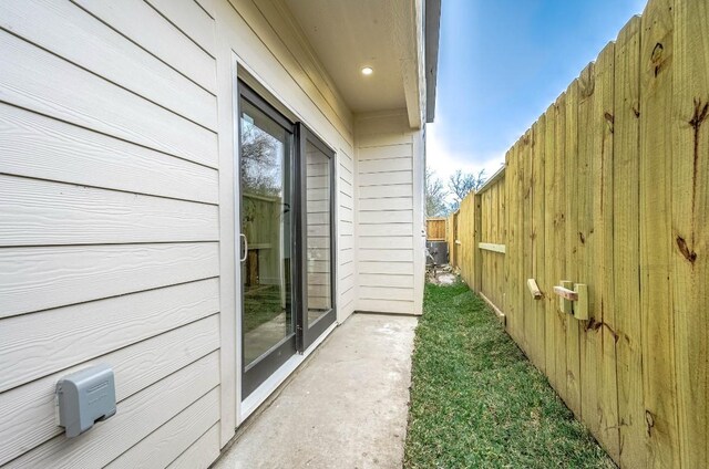 view of side of property featuring central AC