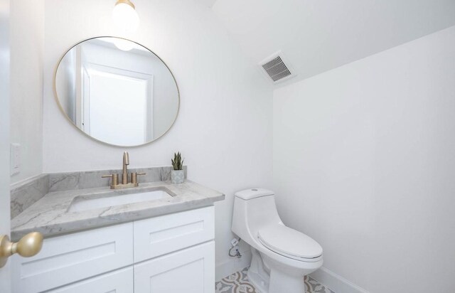 bathroom featuring toilet and vanity