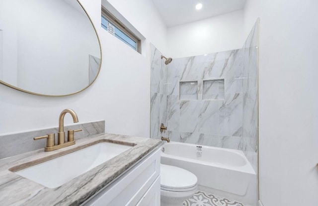 full bathroom with toilet, vanity, and tiled shower / bath