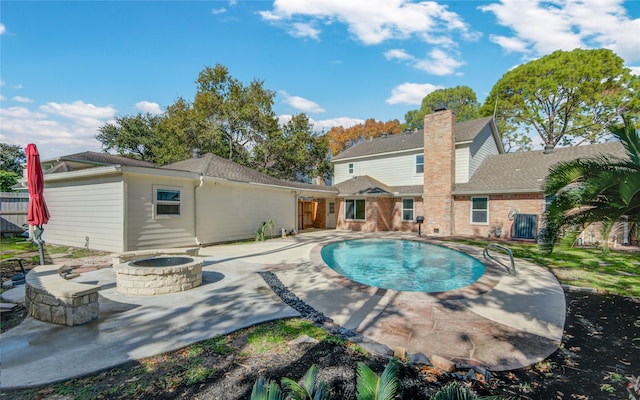 view of pool featuring a patio and a fire pit