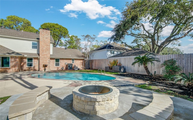 view of swimming pool featuring a fire pit and a patio