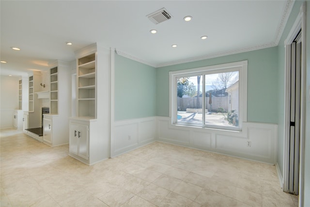 empty room with built in features and ornamental molding