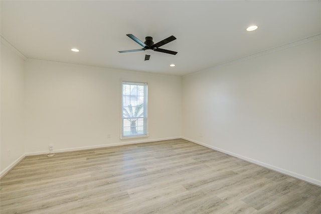 spare room with ceiling fan, ornamental molding, and light hardwood / wood-style floors