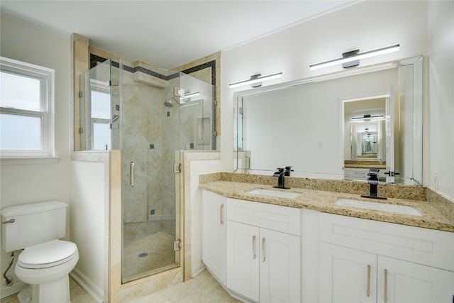 bathroom with an enclosed shower, vanity, and toilet