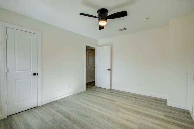 unfurnished bedroom with ceiling fan and light hardwood / wood-style floors