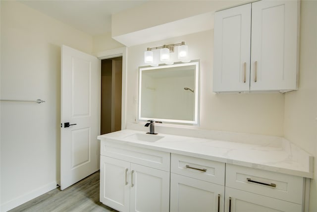 bathroom with vanity and hardwood / wood-style floors