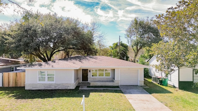 single story home featuring a garage and a front lawn