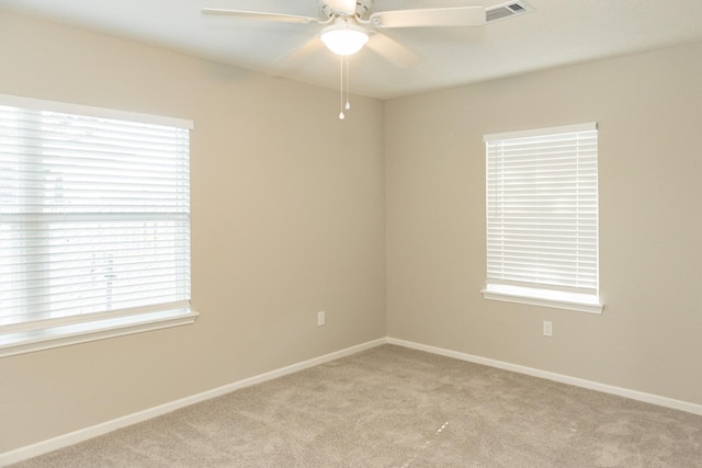 spare room featuring ceiling fan and light carpet