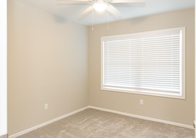 unfurnished room featuring ceiling fan and light colored carpet