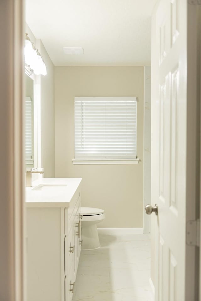 bathroom featuring toilet and vanity