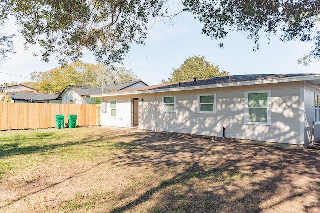 back of property featuring a yard