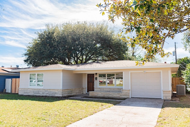 ranch-style home featuring a front yard, a garage, and central AC unit