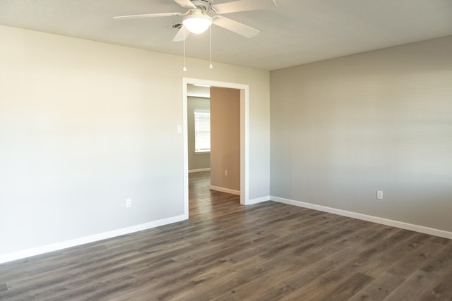 unfurnished room with dark wood-type flooring and ceiling fan