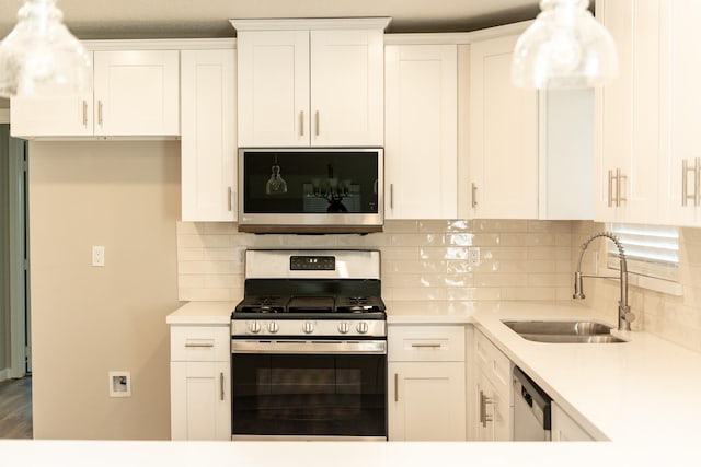 kitchen featuring sink, stainless steel appliances, and white cabinetry