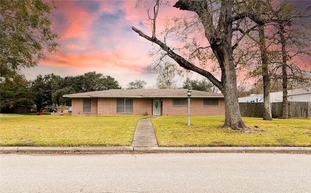 single story home featuring a yard