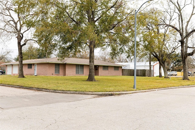 ranch-style house with a garage and a front lawn