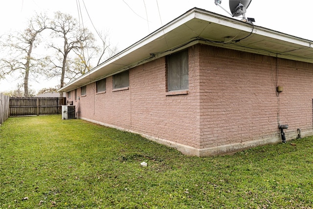 view of home's exterior featuring a yard and central air condition unit