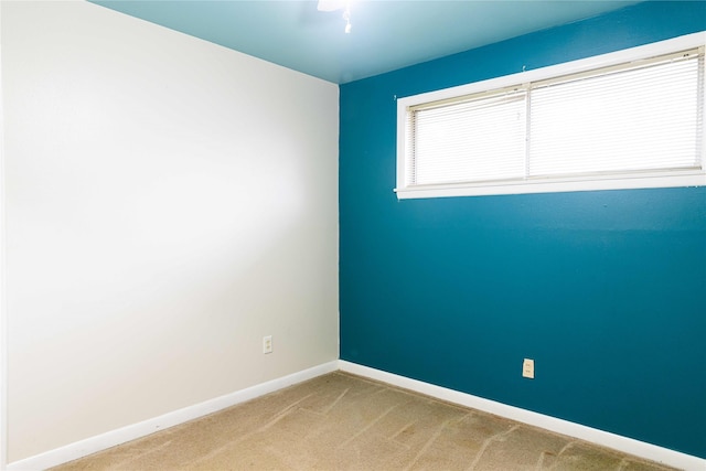 unfurnished room with light colored carpet