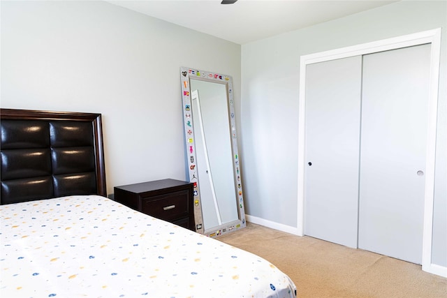 bedroom featuring a closet and light carpet