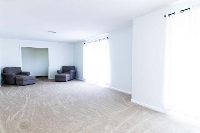 sitting room featuring light colored carpet