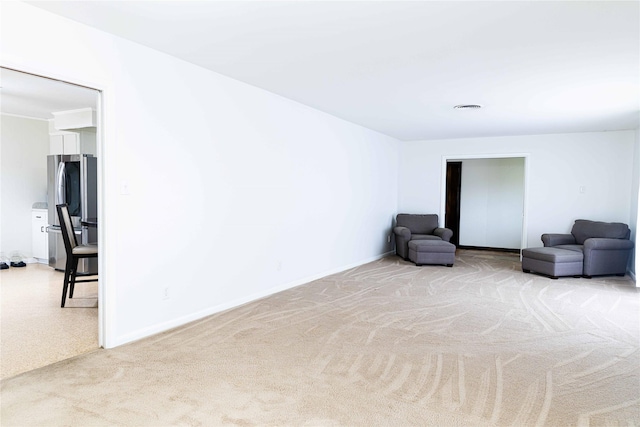 unfurnished room with light carpet