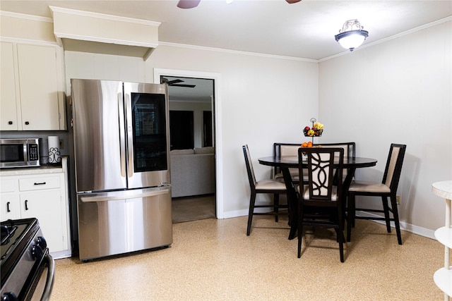 kitchen with ceiling fan, appliances with stainless steel finishes, white cabinetry, and ornamental molding