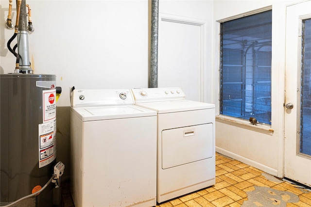 laundry area featuring water heater and independent washer and dryer