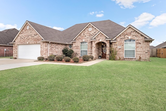 view of front of house with a front lawn and a garage