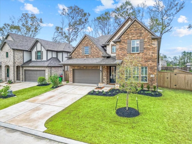 view of front of property with concrete driveway, fence, brick siding, and a front yard