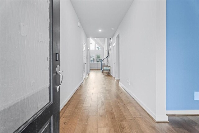 corridor with light hardwood / wood-style floors