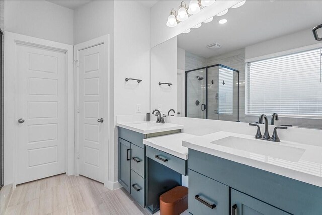 bathroom with an enclosed shower and vanity