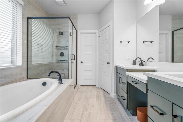 bathroom with separate shower and tub and vanity