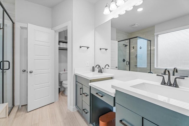 full bathroom featuring visible vents, toilet, a stall shower, and vanity