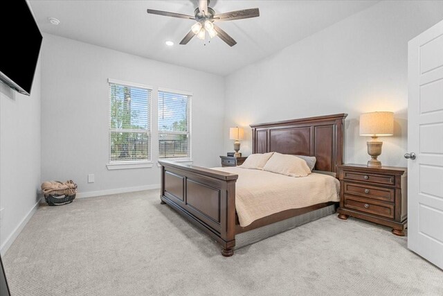 bedroom featuring ceiling fan and light carpet