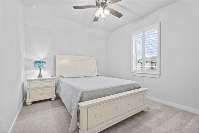 bedroom featuring ceiling fan, light carpet, and lofted ceiling