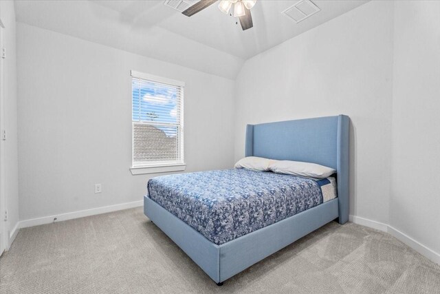 bedroom with ceiling fan, light colored carpet, and lofted ceiling