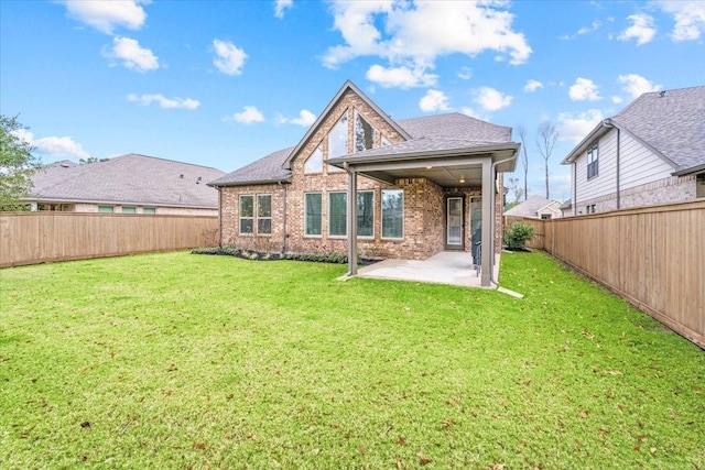 back of house featuring a patio, brick siding, and a lawn