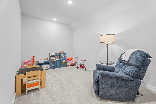 recreation room with carpet floors and lofted ceiling