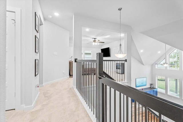 hall with baseboards, high vaulted ceiling, recessed lighting, an upstairs landing, and light colored carpet