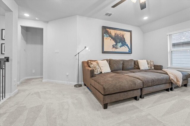 carpeted living room with vaulted ceiling and ceiling fan