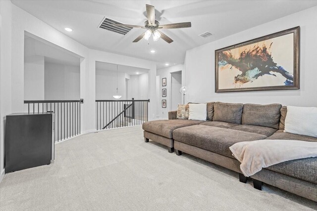 living room featuring carpet flooring and ceiling fan