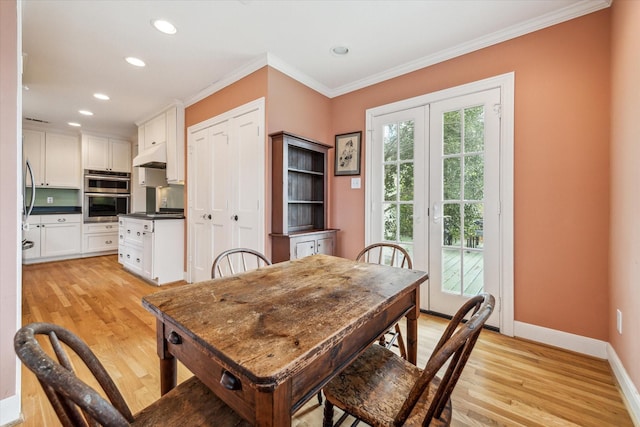 dining space with crown molding and light wood-type flooring