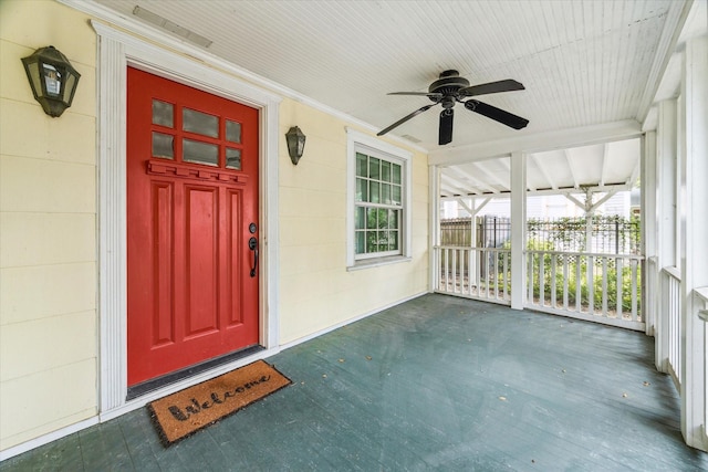 doorway to property featuring ceiling fan and a porch